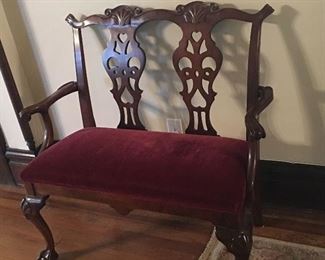 Dark burgundy covered settee.