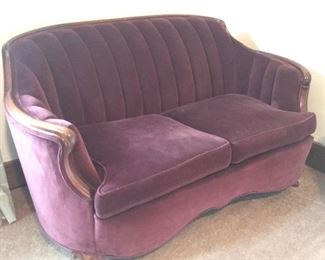 Vintage burgundy velvet covered love seat.