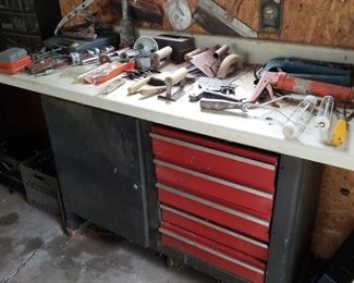 garage with tool boxes and a few tools