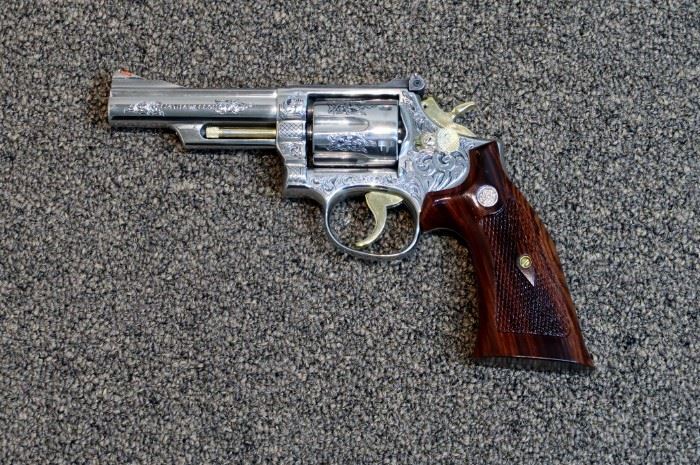 LOT # 21 - SMITH & WESSON MODEL 66-1 STAINLESS STEEL REVOLVER                                                                                                        AUCTION ESTIMATE $2,700.00 - $3,200.00                                                                                                              CALIBER .357 MAG., CUSTOM ENGRAVED BY THE LATE GARY RICHARDS OF GR ENGRAVING IN SAN ANTONIO, TEXAS.  VERY DEEP ENGRAVING WITH BLACK HIGHLIGHTS.  THIS IS AN EARLY MODEL 66 AND IT'S ABSOLUTELY GORGEOUS AND THE GUN IS NEW