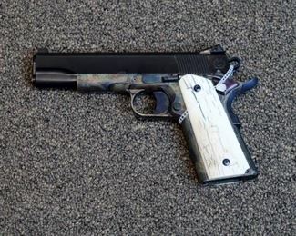 LOT # 62 - CUSTOM CASPIAN ARMS 1911 PISTOL BY  THE RENOWNED NEW BRAUNFELS GUN WORKS                                                                                     AUCTION ESTIMATE - $3,000.00 - $4,000.00                    CALIBER .45ACP, CASE HARDENED FRAME, STI SLIDE WITH BLUED FINISH, KKM BARREL, WILSON COMBAT TRIGGER, BUSHINGS AND SPRINGS, NOVAK SIGHTS, MAMMOTH IVORY GRIPS CONDITION IS NEW