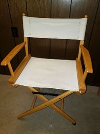 Three director's chairs. 2 ivory, 1 purple.