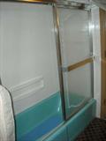 Turquoise blue tub with shower doors
