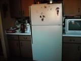 Refrigerator, television, kitchen cabinets