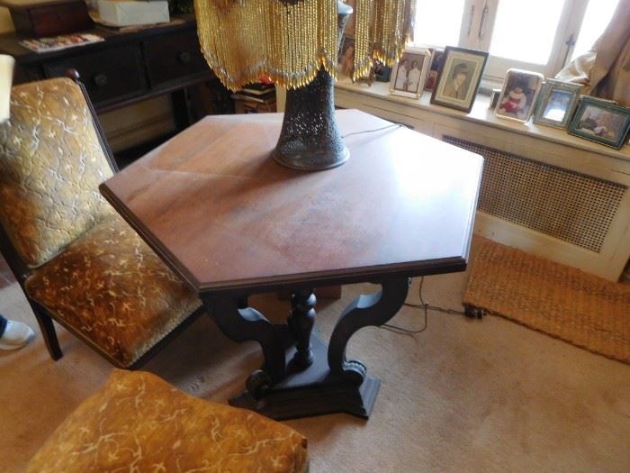 six  sided  table  and  gold  chairs