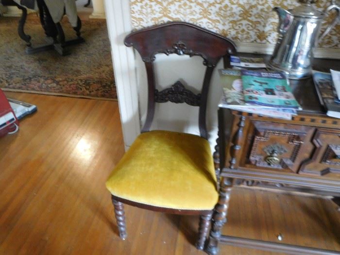 one of three chairs with gold fabric