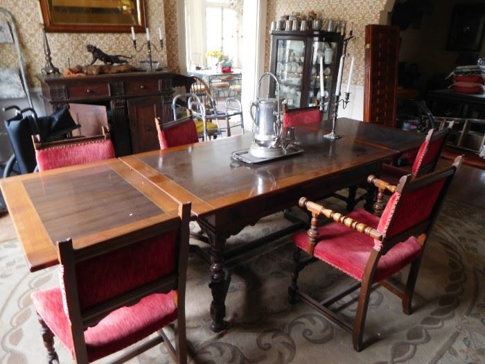 refractory dining  room  table  with  red  chairs