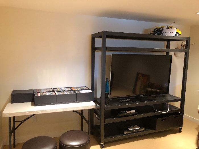 Dvds, two stools and a terrific Room & Board rolling tv shelf for sale  Shelving unit measures 63"w x 20"d x 71"h  asking $640 for the entertainment shelf
