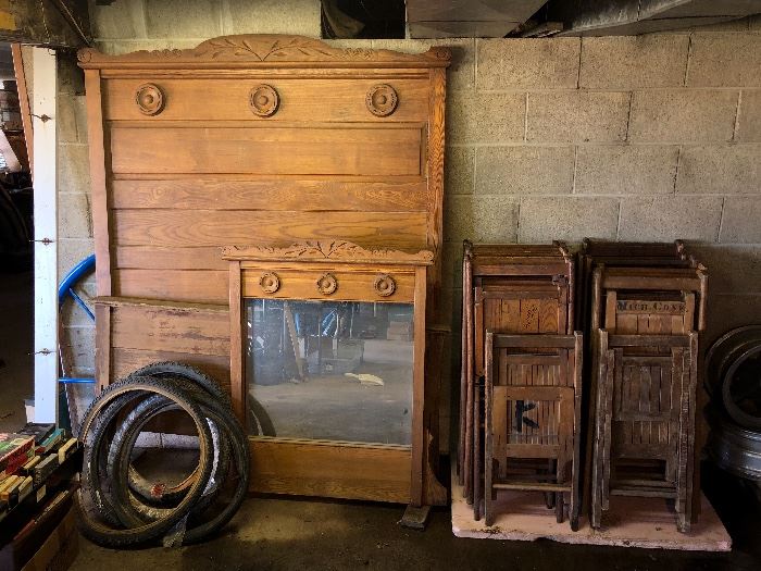 Victorian era headboard and footboard, mirror, and vintage wooden folding chairs