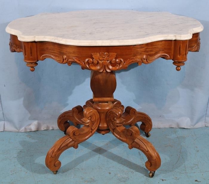 132a  Walnut Victorian turtle top center table with dolphin heads on base with white marble, 29 in. T, 38 in. W, 26 in. D.