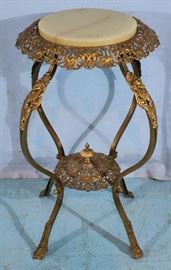 283a  Brass Victorian pedestal with onyx top and ladies heads on legs, 32 in. T, 18 in. Dia.