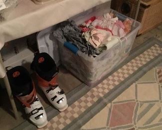 Ladies snowboots and tub of baby clothes