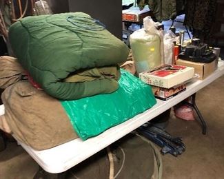 Cold weather sleeping bags, towing inner tube (3) w/ canvas covers, timing light, old camera
