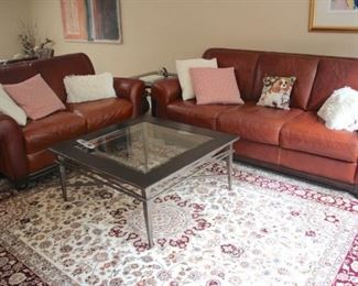 Two Piece Like New Leather Sofa Set with Handmade Rug 8×10 and Metal & Glass Coffee Table with Accent Pillows