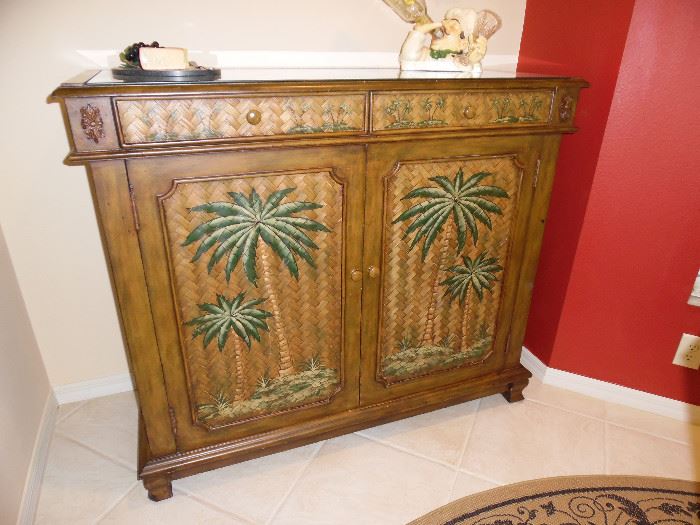 Palm Design Cabinet is set up as a Bar