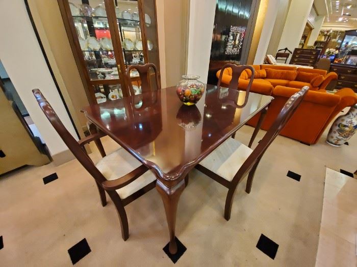 Cherry dining table and four chairs.  The hutch in the background could also be used as a curio in a bedroom, living room, etc.  I personally love the size - it's a thinner piece, which doesn't take up as much room.
