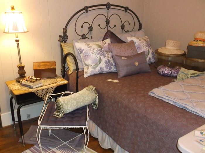Full size iron bed, vanity bench, and some of the many throw pillows