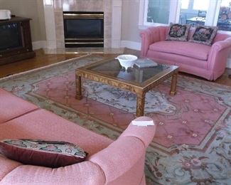 Large rug and glass top coffee table