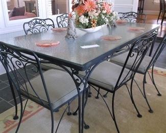 Glass top wrought iron table and six chairs