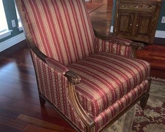 Upholstered armchair with carved wooden trim