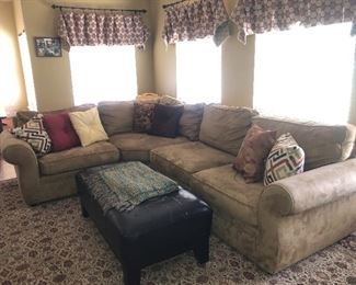 L-shaped sectional sofa, large area rug, large tufted ottoman coffee table