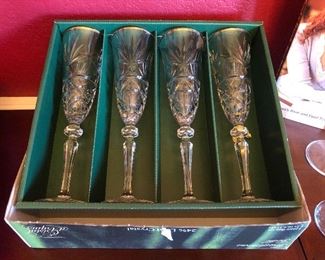 Set of four cut crystal champagne flutes in box