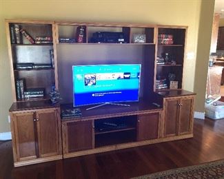 Three-piece solid wood entertainment center with bookcase shelving and bottom storage, Samsung Curved Flat Screen 4K, PlayStation Call of Duty Special Edition 