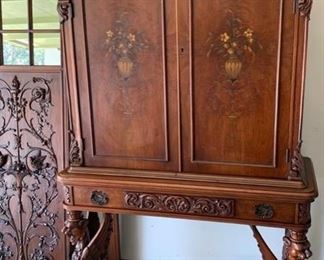Cabinet on Base, hand carved wood, figural Griffin Legs next to Edwardian folding screen with relief carving and mirror panels