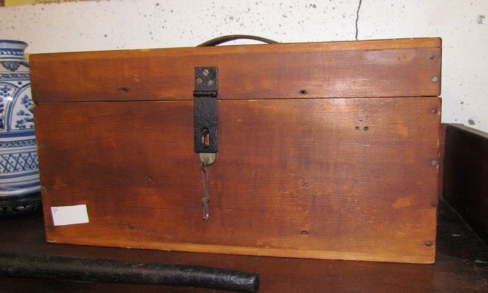 Carrying case, probably covered originally in cloth or leather.  Original lock and key.