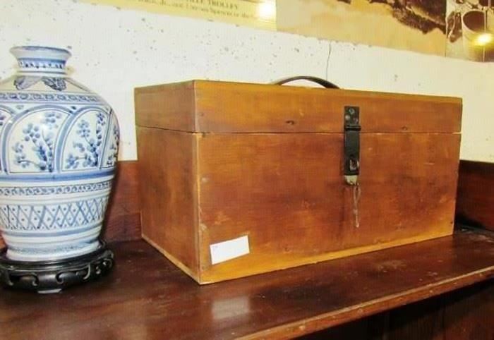 Carry case with lock and key, originally covered with cloth or leather.  