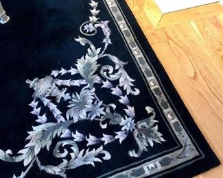 Black room rug with silver and white design