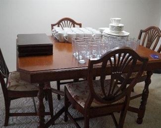table with chairs, glasses, dishes