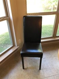 One of 6 black leather dining chairs