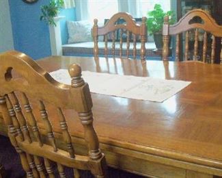 Large Dining Room table with four chairs and two captain's chairs.  Solid wood.