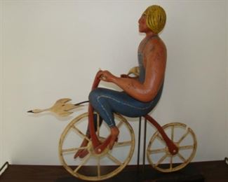 Carved Wooden figure on bicycle by William Jauquet