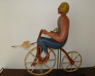 Carved Wooden figure on bicycle by William Jauquet 