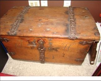 Antique Norwegian ornamental hinged trunk with initials J & H carved on the front.