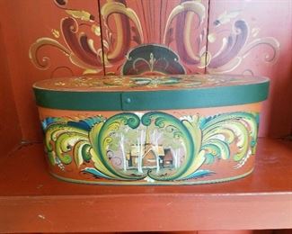 Rosemaling oval box with lid on bench.