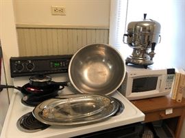Nordic Ware, cast-iron skillet, stainless steel bowl and serving tray. Stove is not for sale.