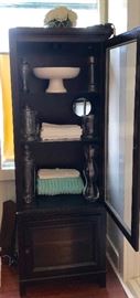 Tall black storage cabinet.  Top and bottom glass front cabinets with five shelves.