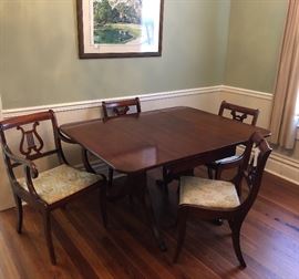  Mahogany dropleaf Duncan Phyfe table and 4 upholstered chairs. Three straight, one master.  Brass feet. Absolutely beautiful condition!