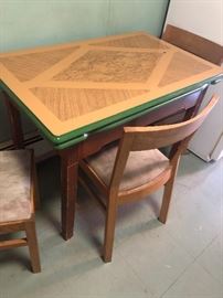The leaves push under the table. It has a fun pattern on the top with green accent