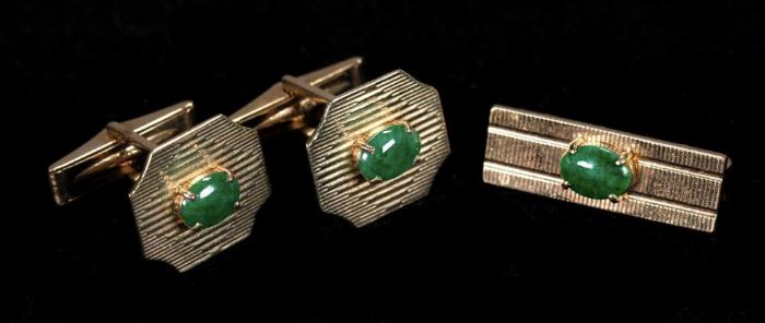 Description: Pair of 14k yellow gold cufflinks with spinach jade cabochon and matching tie clasp. All marked 14K. 
Tie clasp length: 1 1/8 inches. Cufflinks: 5/8 x 1/4 inches. 
Actual weight: .52 ounces troy.
Dimensions: 6 3/4 inches.