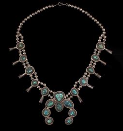 Description: Unmarked silver squash blossom comprised of 10 turquoise inset tin cones and a horseshoe form turquoise inset naja. Length: 24 3/4 inches. 
Weight: 7 ounces. 
 Dimensions: Overall: 13 inches.
Notes: 7 ounces.