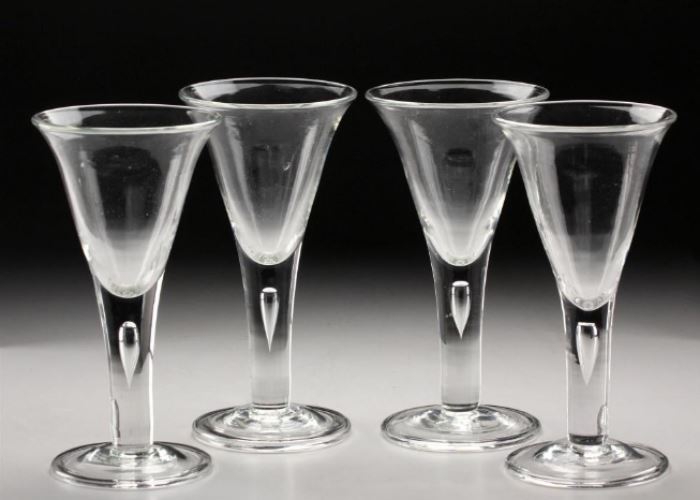 Four Continental Crystal Wine Glasses                       Description: Lot consists of four matching stemmed wine glasses with trumpet bowl on tear drop bubble in the tappered stem on a conical circular base. 
Height: 7 7/8 inches. 
Weight: 4 lbs. 
Material: Crystal. 
Condition: Good.
Dimensions: 62 1/2 inches
Notes: 4 lbs.