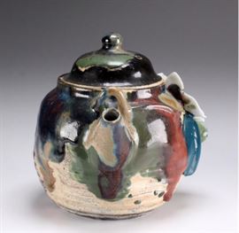 Japanese Meiji Period Sumida Gawa Ceramic teapot         Description: A ceramic teapot in a partial unglazed ribbed body and heavy drip glaze in brown, tan and green to top, Applied large white blossom and leaves to side.                                                                                             Unmarked.                                                                                   
 Shipping weight: 8 ounces. 
Size: H. 6 Inches