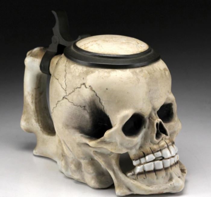 German Skull Form Porcelain & Pewter Stein Description: Porcelain skull form stein with pewter mounts. Marked under the pewter rim _0.5L. With porcelain detailed teeth.                                                 Condition: Hairline spider crack evident on underside of lid.                                                                                                           height 5 1/2 inches.                                                                     Width: 8 inches.                                                                        
Shipping weight: 2 1/4 lbs.
Dimensions: Height of larger: 9 3/8 inches.
