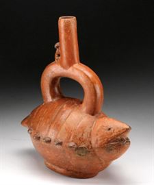 PreColumbian Ceramic Lobster Form Stirrup Vessel     Description: Lobster form stirrup vessel with monkey astride the spout. 
Condition: Fair, the two front claws missing. 
Size: Height: 10 inches; Width: 8 3/4; Depth: 5 inches. 
Weight: 1 lb. 
Provenance: Label on base: Stanton Ross, 556.41 and ink inventory inscribed: L.H.R. 230.
Condition Report: Fair
Notes: 1 lb.