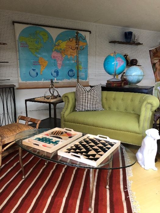 Vintage Kilim rug, industrial side tables, vintage maps and globes, dog by Royal Haeger. 