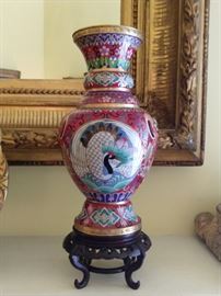 One of the pair of red cloisonne vases.